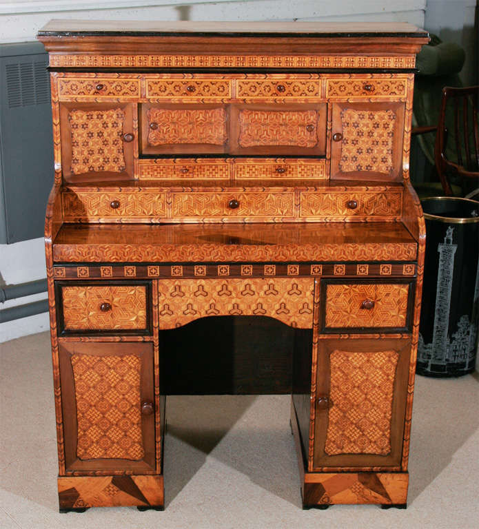 The superstructure fitted with cupboards enclosed by two sliding and panelled doors. The top with a writing slide. Fitted cupboards behind doors.<br />
28”wide 19.5”deep 48”high